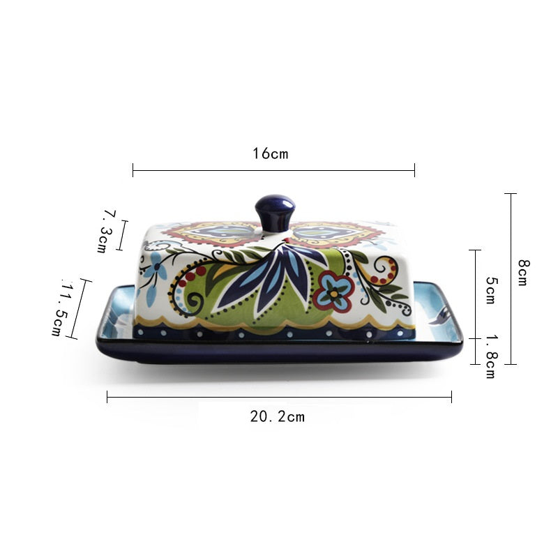 Ceramic butter dish with floral design and measurements on a white background