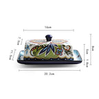 Ceramic butter dish with floral design and measurements on a white background