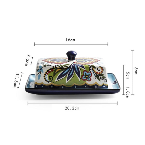 Ceramic butter dish with floral design and measurements on a white background