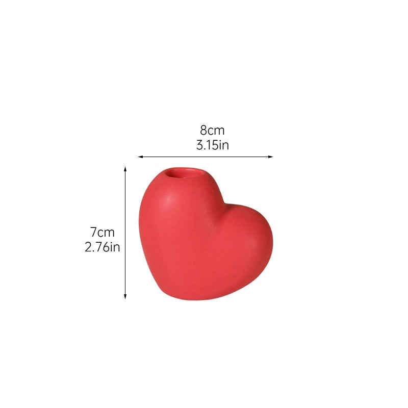 Red heart-shaped object with dimensions on a white background