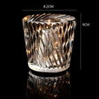 Decorative glass candle holder with embedded lights, shown with dimensions on a black background.