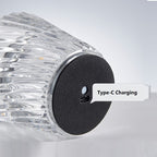 Clear cylindrical device with black charging port labeled 'Type-C Charging' on a light gray background