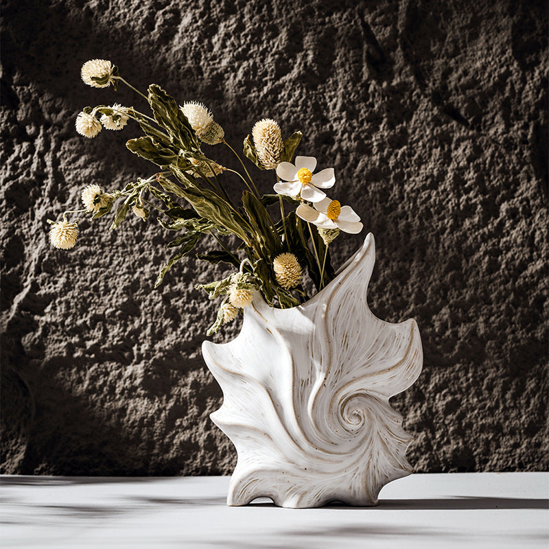 Modern white shell-shaped ceramic vase with sculptural spiral texture for coastal home decor