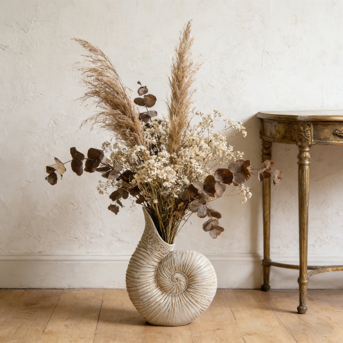 Vintage ivory nautilus shell ceramic vase with textured spiral design for coastal home decor