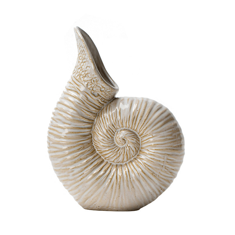 Decorative vase shaped like a nautilus shell on a white background
