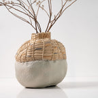 Vase with woven top and textured base on a white background